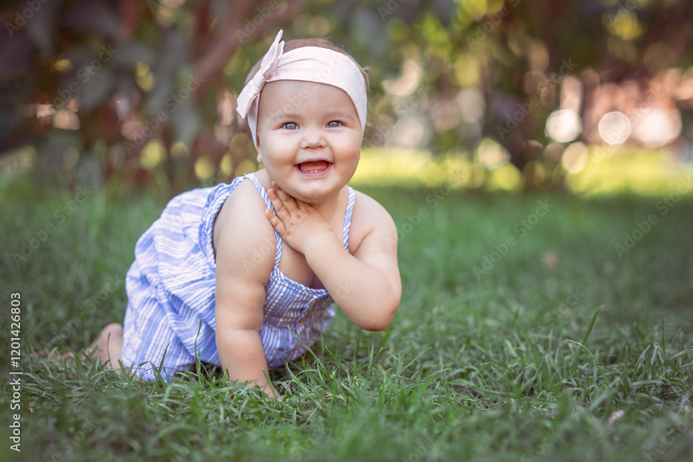Funny child toddler playing and having fun on summer day. A Happy adorable baby girl sitting on the grass Funny child toddler playing and having fun on summer day. A Happy adorable baby girl sitting on the grass