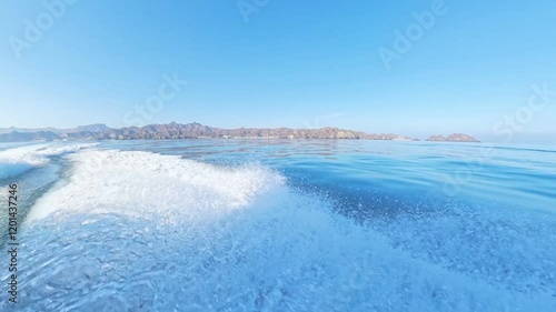 Speeding up motor boat rear view