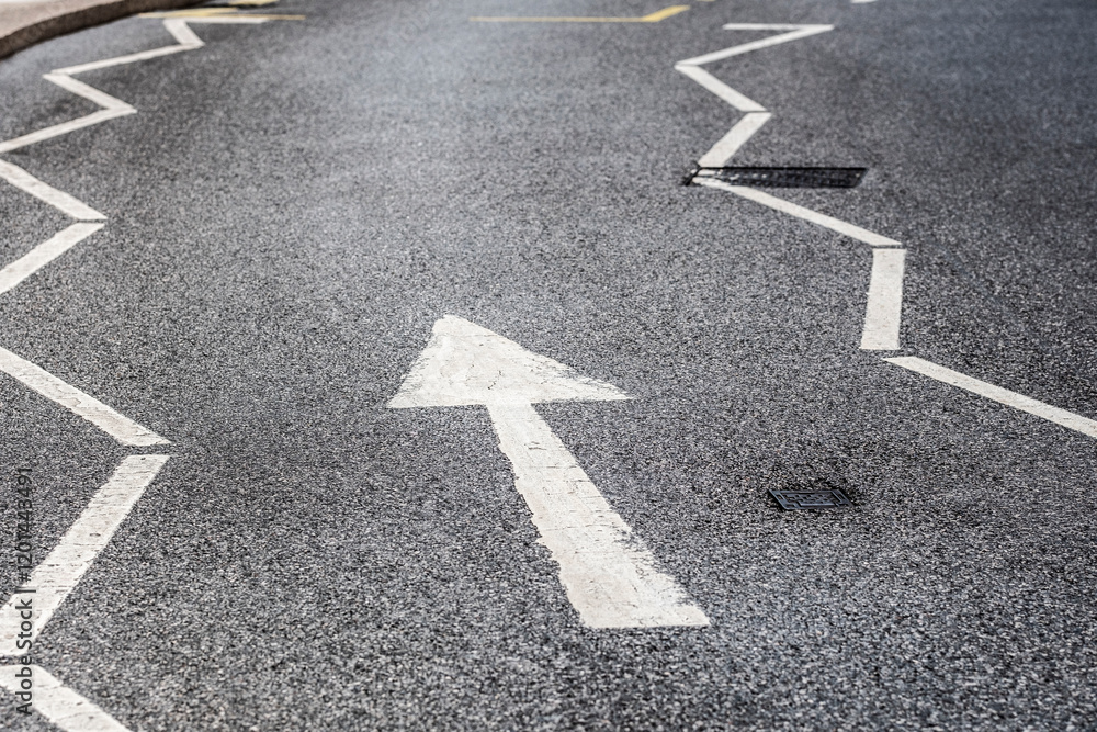 This image features a close-up of a zigzagged road marking directing traffic, emphasizing urban navigation and the importance of transportation in city living. This image features a close-up of a zigzagged road marking directing traffic, emphasizing urban navigation and the importance of transportation in city living.