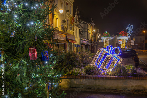 Normandy, France -12- 30- 2024 : Exterior night photo view of christmas light decorations for xmas celebrations decor evening with garlands and tinsel lights,