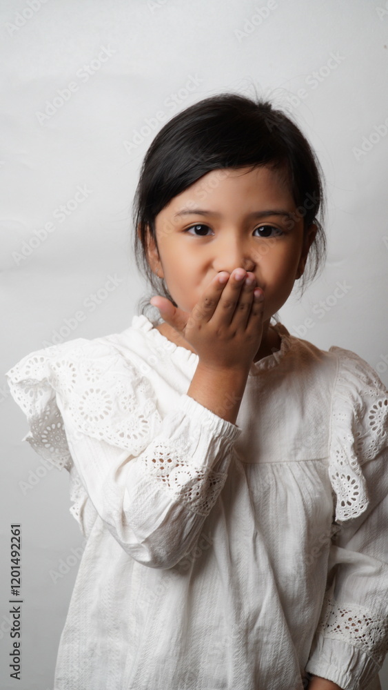 Portrait of an Asian girl wearing a white shirt posing for a kiss bye on a white background.
Portrait of an Asian girl wearing a white shirt posing for a kiss bye on a white background.