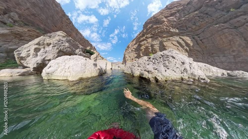 Wadi swimmer swimmin in an Oman oasis