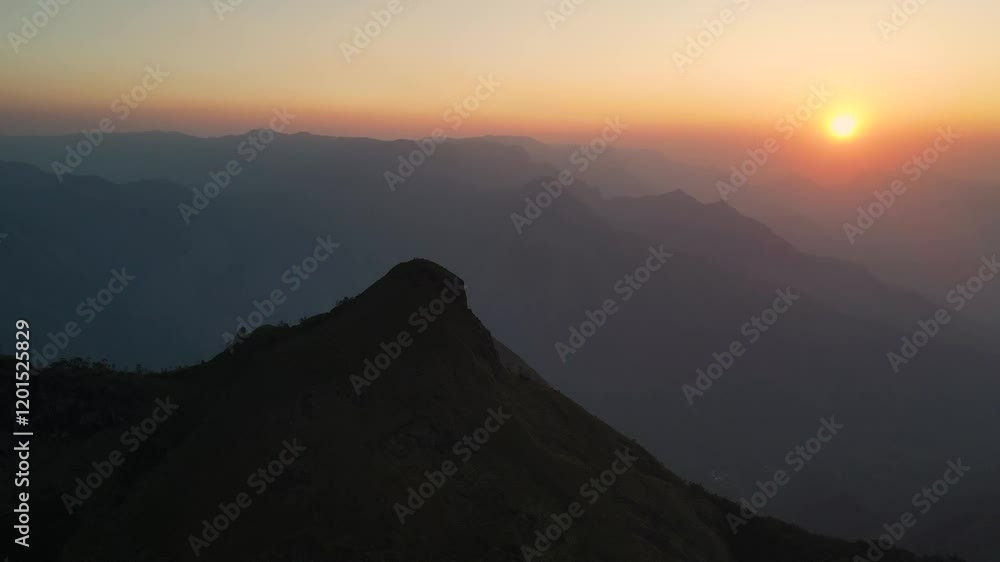Aerial Drone Shot of Kolukkumalai Range, Wrapped in Morning Mist with Sunlight Breaking Through Aerial Drone Shot of Kolukkumalai Range, Wrapped in Morning Mist with Sunlight Breaking Through