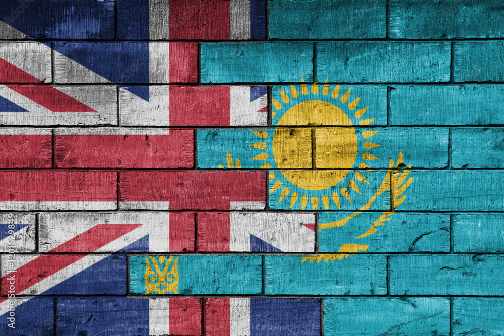 Fototapeta premium colourful painted big flag of great britain and flag of kazakhstan on a massive old brick wall background. concept