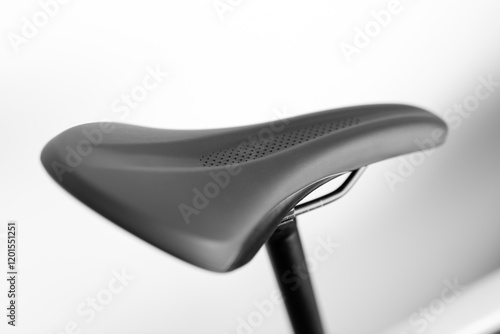 A black bicycle seat with a mesh design. The seat is positioned on a white background. Concept of modernity and functionality, as the mesh design allows for breathability and comfort while cycling photo