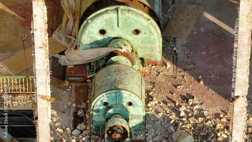 A view of an old turbine in a power plant being taken down photo