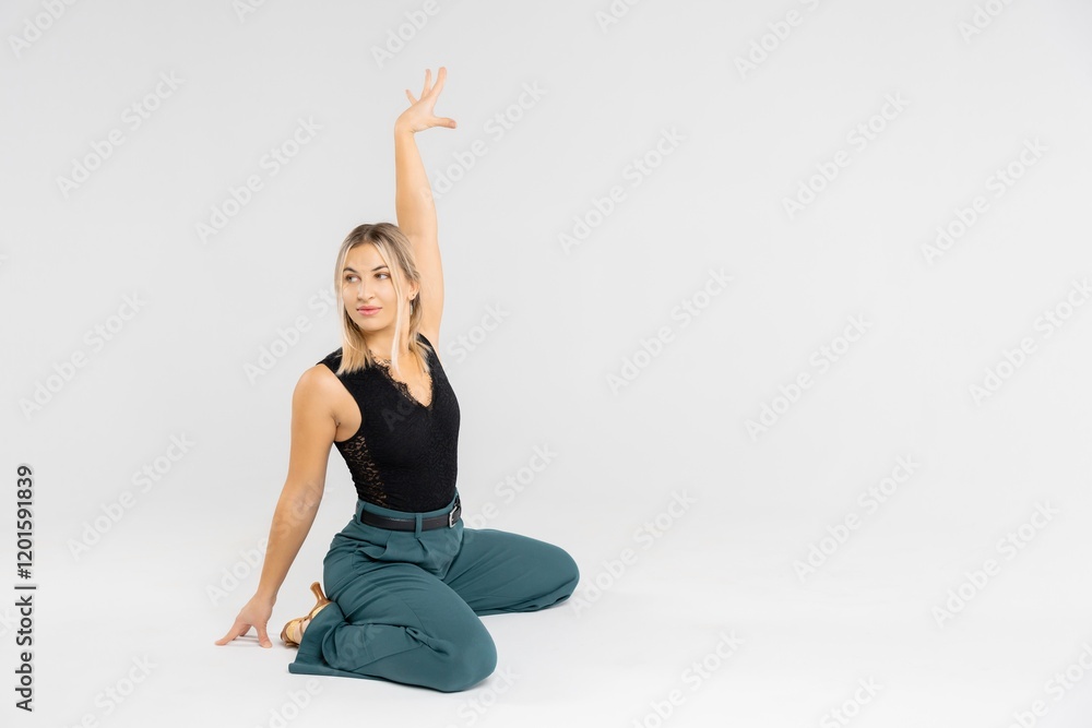 Professional dancer performing a modern dance move with raised arm Professional dancer performing a modern dance move with raised arm