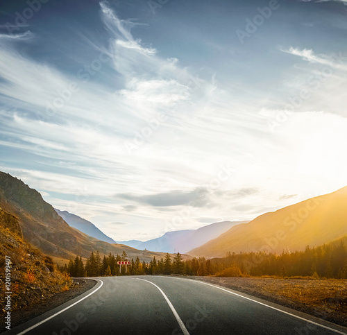 autumn mountain road at sunset