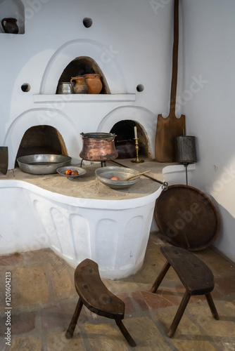 Bulgarian Renaissance traditional home interior with fireplace and traditional tableware and furniture photo