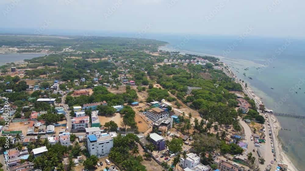 Immersive aerial drone shot of Rameshwaram city, with the temple standing prominently in the urban landscape. Immersive aerial drone shot of Rameshwaram city, with the temple standing prominently in the urban landscape.