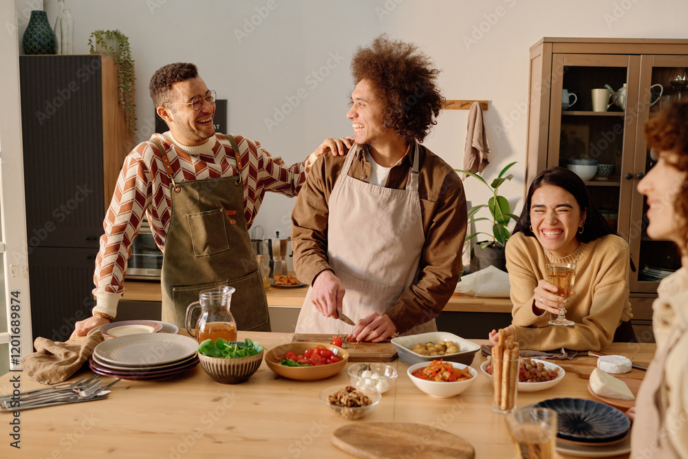© AnnaStills - Smiling young adult Caucasian man with short hair joking and patting curly haired biracial friend on shoulder while last cutting tomatoes, young adult woman leaning on table and laughing out loud © AnnaStills - Smiling young adult Caucasian man with short hair joking and patting curly haired biracial friend on shoulder while last cutting tomatoes, young adult woman leaning on table and laughing out loud