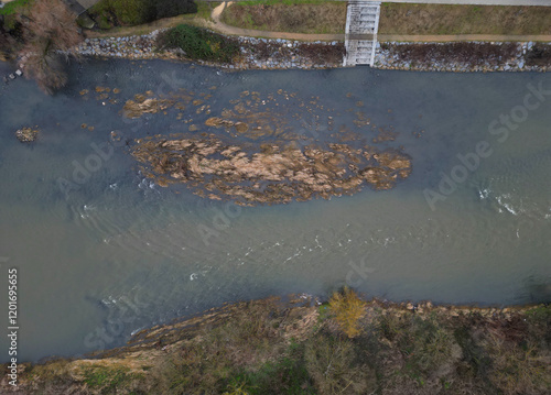 newly created natural embankment by river. benches, terraces, relaxed staircase serve people as well as fishing and relaxation. strengthening banks against water erosion by large stones on dry lined photo