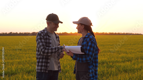Handshaking in agriculture. two farmers agreement for teamwork in agricultural field. Handshake in sign of teamwork in green wheat field. agricultural business
