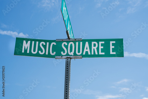Sign marking the intersection of Music Square E in Nashville, Tennessee on a sunny day in a lively urban environment