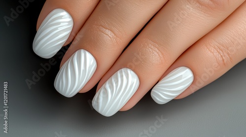 Elegant white nails with a textured wave design, showcasing a modern manicure style. photo