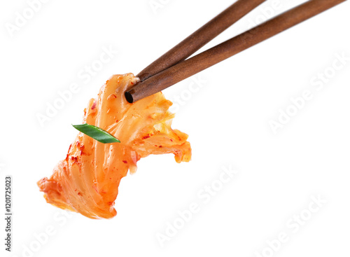 Chopsticks holding kimchi cabbage on white background. Hot fermented napa cabbage.