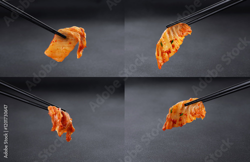 Chopsticks holding kimchi cabbage on dark background. Hot fermented napa cabbage. Collection.