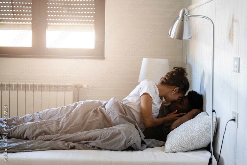A couple enjoying an intimate and affectionate moment in bed, wrapped in a cozy blanket, with a bright, serene bedroom background A couple enjoying an intimate and affectionate moment in bed, wrapped in a cozy blanket, with a bright, serene bedroom background