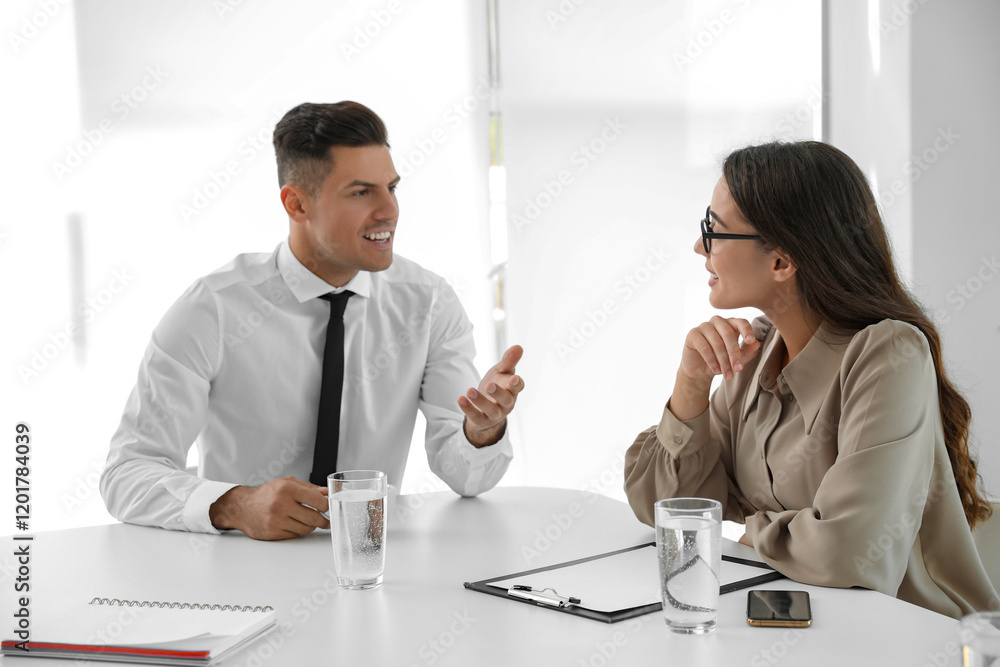 Fototapeta premium Office employees talking at table during meeting