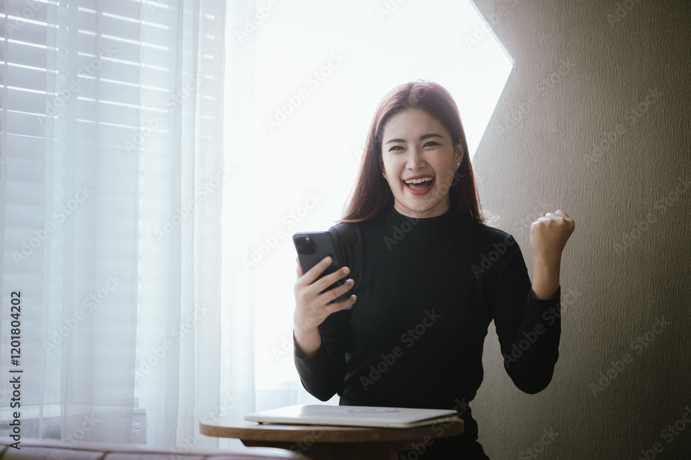Young Asian woman smiling while using smartphone and holding credit card to buy things online. Image highlights e-commerce, finance, technology and convenience of digital transactions. Young Asian woman smiling while using smartphone and holding credit card to buy things online. Image highlights e-commerce, finance, technology and convenience of digital transactions.
