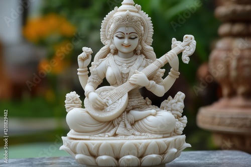 hindu a goddess saraswati sitting on a white lotus and playing a traditional instrument veena. photo