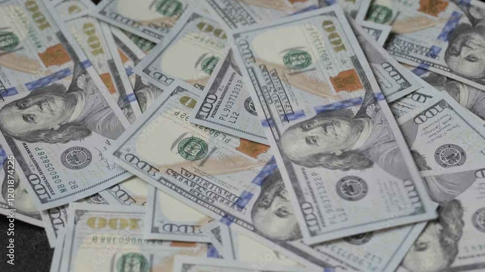 American dollars fall on the table. A pile of hundred dollar bills American dollars fall on the table. A pile of hundred dollar bills