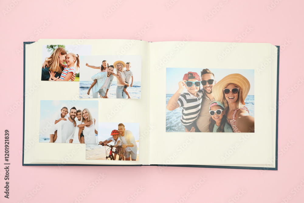 © New Africa - Open photo album with different photos on pink background, top view