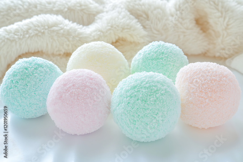 A high-quality photograph of soft, fluffy marshmallows in pastel colors, neatly arranged on a white surface with soft lighting, creating a cozy atmosphere