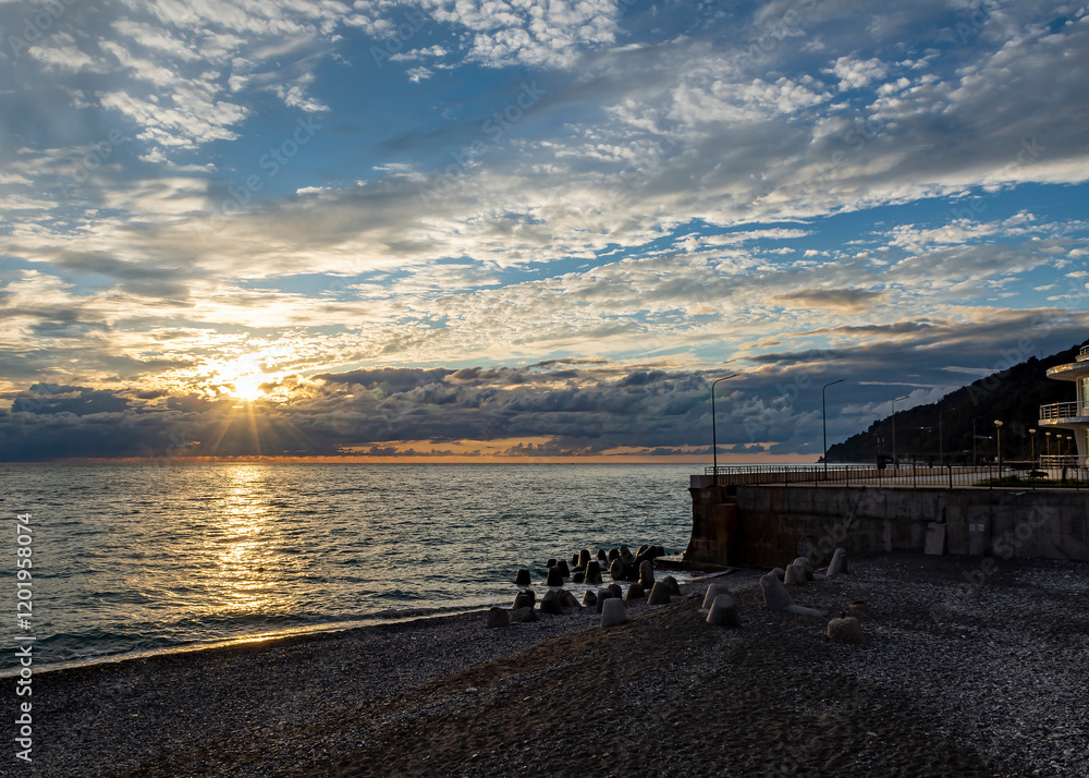 Dramatic sky with dark clouds on calm sea at sunset. Black Sea coast, early autumn. Deserted beach. Dramatic sky with dark clouds on calm sea at sunset. Black Sea coast, early autumn. Deserted beach.