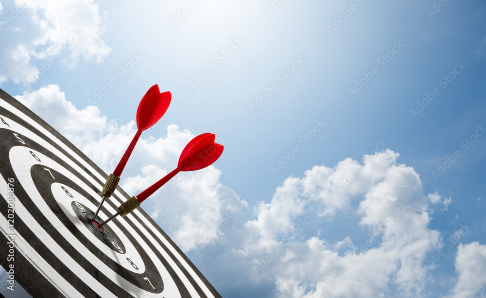 two red darts on target with cloud background two red darts on target with cloud background