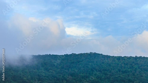 Landscape of sky, clouds and mountain. 4K 3840x2160, zoom out to wide shot. Can be establishing shot. Time lapse.