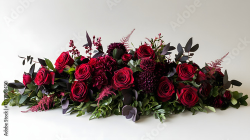 Elegant Floral Design Featuring Red Roses and Dark Green Leaves