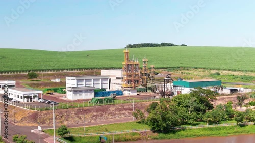 Wallpaper Mural Drone shot capturing small refinery with beautiful green field at background. Torontodigital.ca