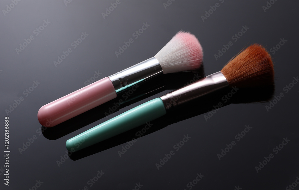 Pink and blue makeup brushes on black background Pink and blue makeup brushes on black background