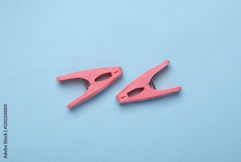 Plastic clothespins on a blue background. Plastic clothespins on a blue background.