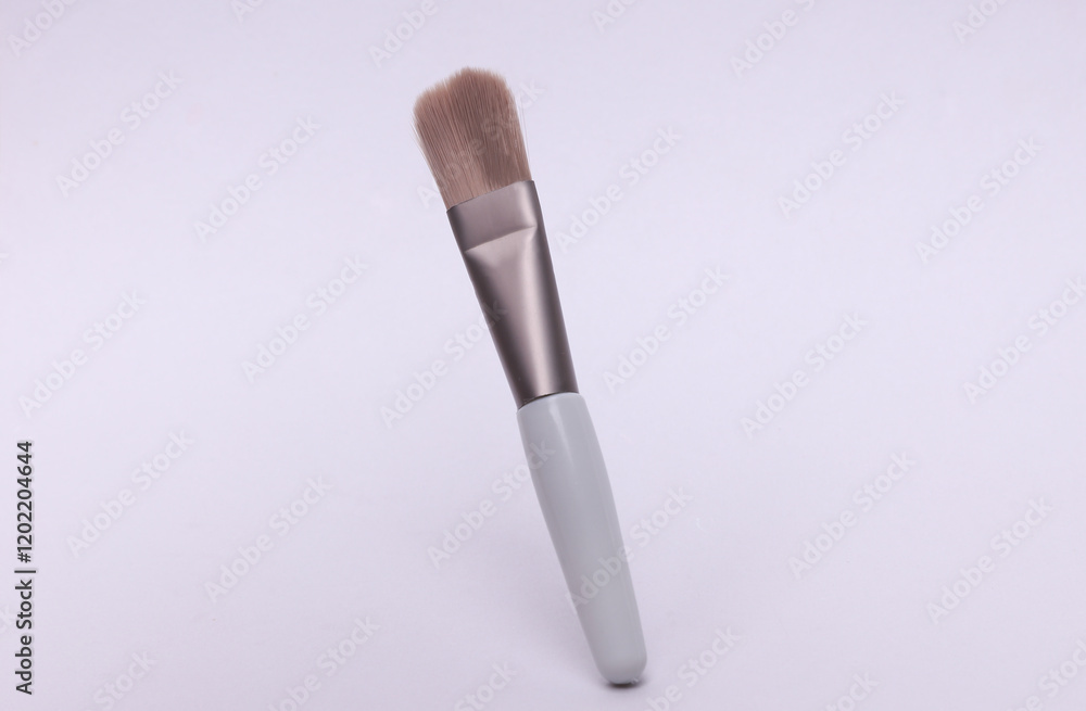 Gray makeup brush floating on white background Gray makeup brush floating on white background