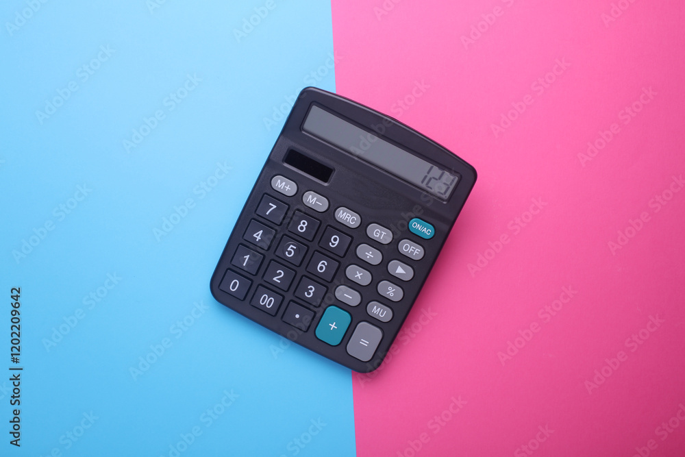 Black classic calculator on pink blue background. Top view Black classic calculator on pink blue background. Top view