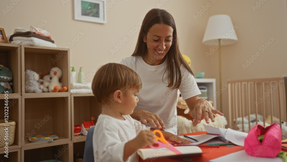 Woman smiling with son indoors in cozy bedroom doing crafts surrounded by toys showcasing family love and warmth in intimate home setting. Woman smiling with son indoors in cozy bedroom doing crafts surrounded by toys showcasing family love and warmth in intimate home setting.