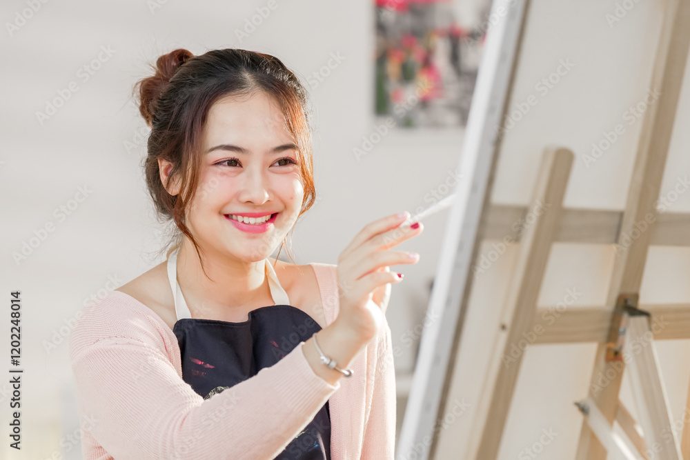 artist lifestyle. painting hobby. Artistic girl. Smiling portrait on young Asian female artist, Asian woman spending weekend morning painting in studio room at home. artist lifestyle. painting hobby. Artistic girl. Smiling portrait on young Asian female artist, Asian woman spending weekend morning painting in studio room at home.