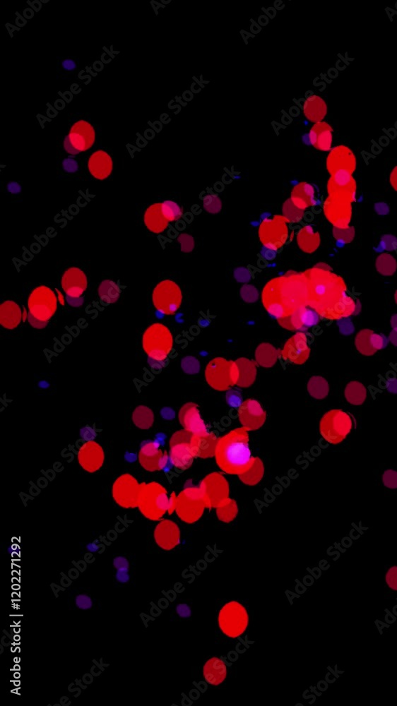 Vertical video with Bright neon red pink confetti particles spread across a black background Vertical video with Bright neon red pink confetti particles spread across a black background