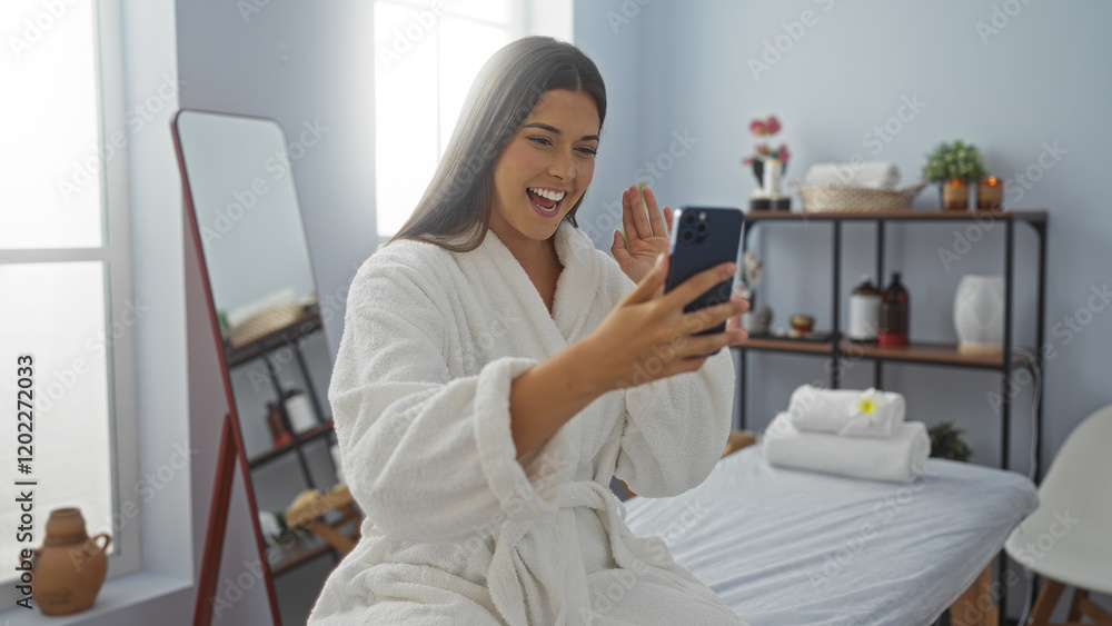 Woman talking on phone in a spa while wearing a robe, with wellness and beauty items in the background, enjoying a relaxing moment indoors Woman talking on phone in a spa while wearing a robe, with wellness and beauty items in the background, enjoying a relaxing moment indoors