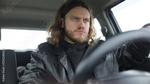 an emotional man driving a car