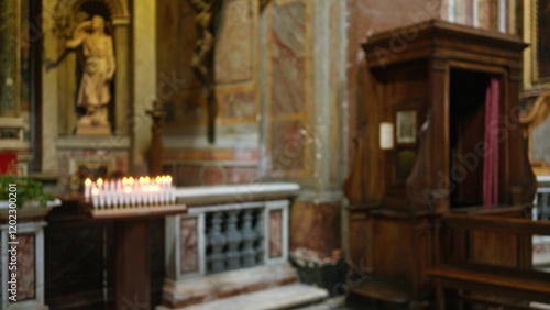 Candles softly illuminate a blurred historic church interior with wooden pews and religious iconography  evoking a serene and spiritual atmosphere perfect for reflection.