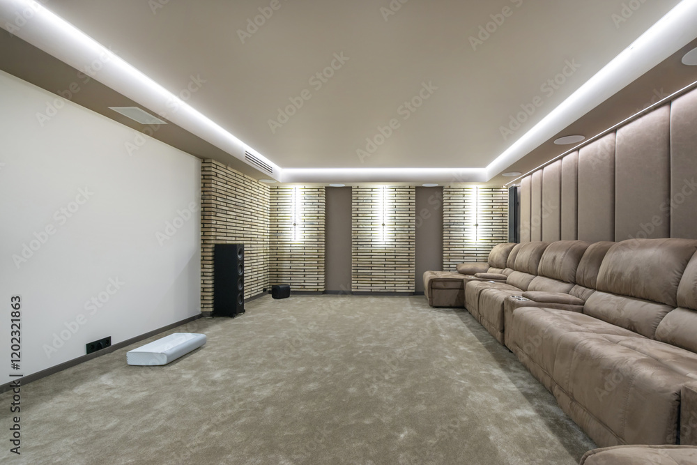Obraz premium The interior of a home theater with a large screen and upholstered sofas for comfortable viewing.
