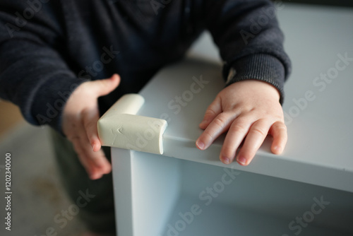 Baby safety table corner protector for furniture. Kid and toddler safety concept.