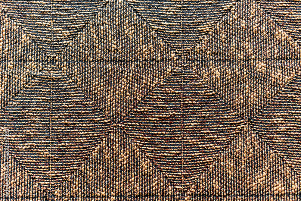 Fototapeta premium A brown and black patterned rug with a diamond shape design