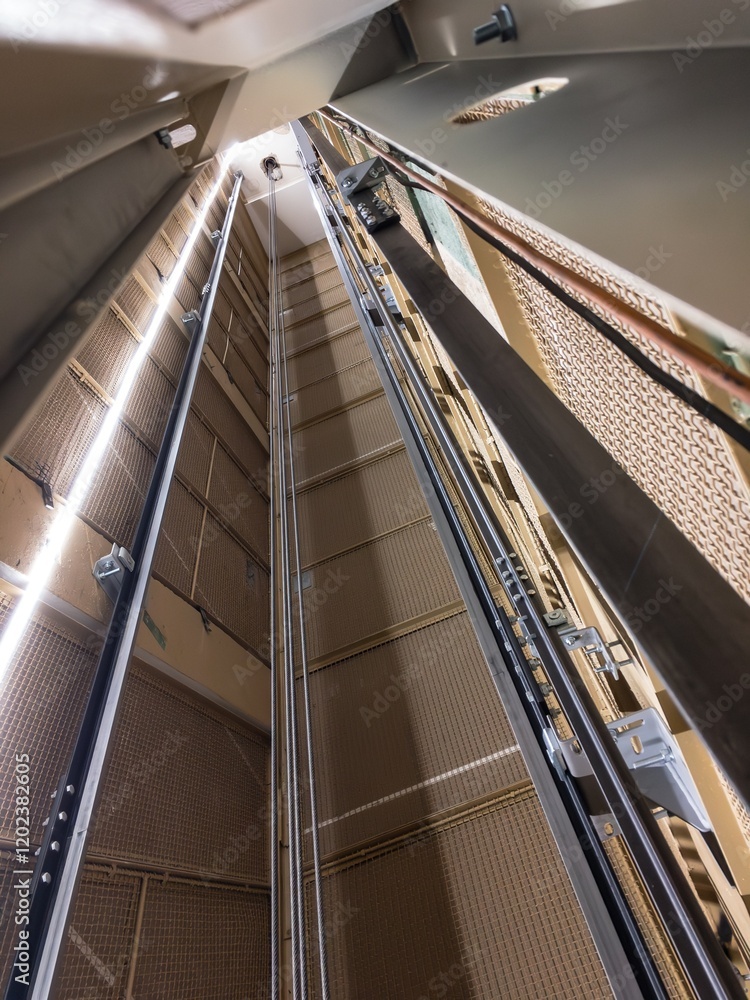 Reconstruction of elevator shaft with ropes and LED lights, vertical