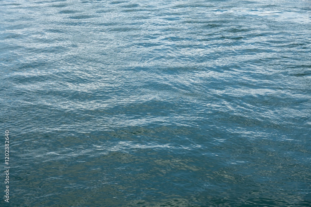 Blue abstract water surface with small waves and ripples