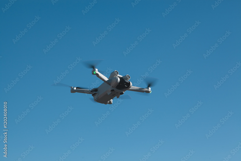 drone flying in cloudy blue sky, copy space. drone flying in cloudy blue sky, copy space.