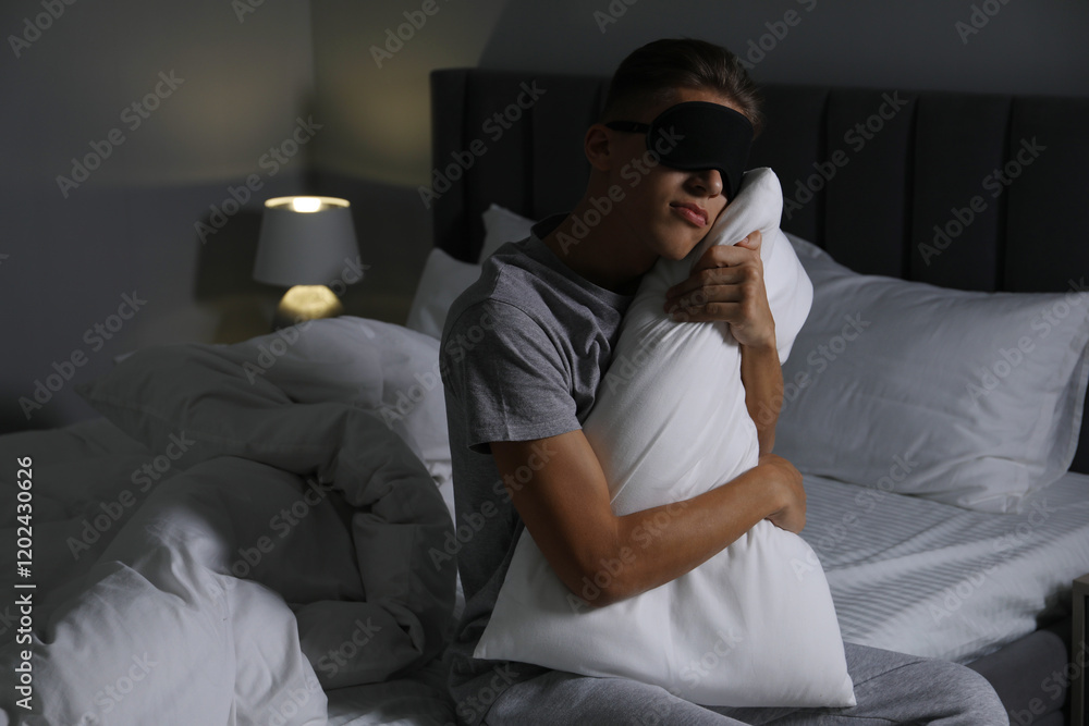 Fototapeta premium Young man suffering from sleepwalking on bed at home